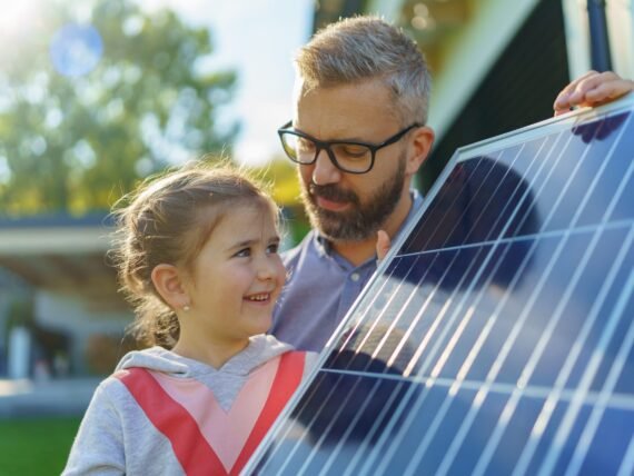 Father,With,His,Little,Daughter,Near,Their,House,With,Solar